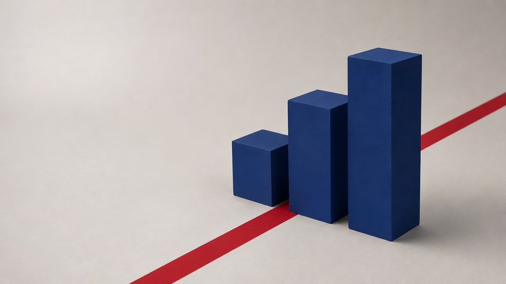 Three matte navy blocks of increasing height standing in a row like a staircase on a pale studio floor, a red stripe running diagonally behind them.